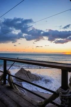 Vertical View of Sunset Over Waves from Terrace Stock Photos