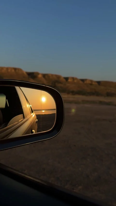Vertical View of Sunset Reflection in Car Side Mirror Stock Footage 342133464