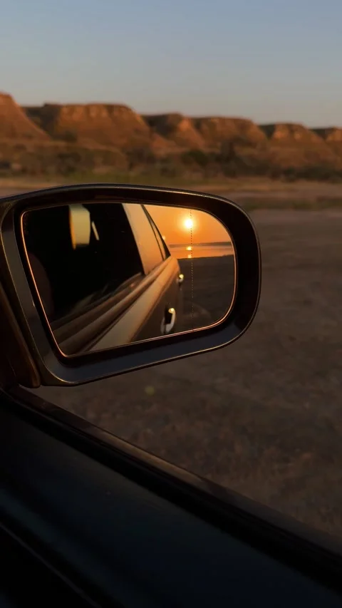 Vertical View of Sunset Reflection in Car Side Mirror Stock Footage 342133468