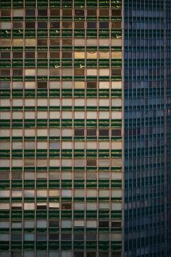 Vertical view of a tall modern office building glass facade with telecommunic Fotos de archivo