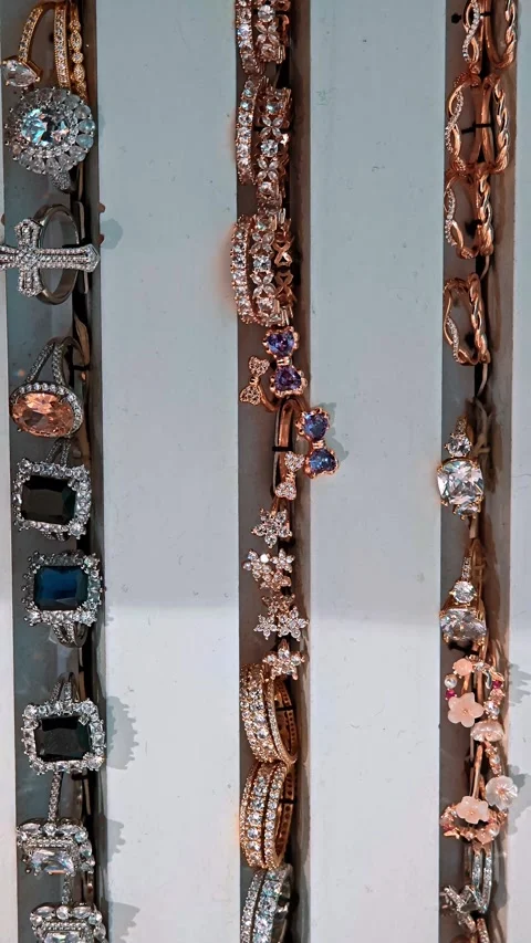 Vertical view of thin holders with crystal decorated rings, elegant shop Stock Footage 330786600