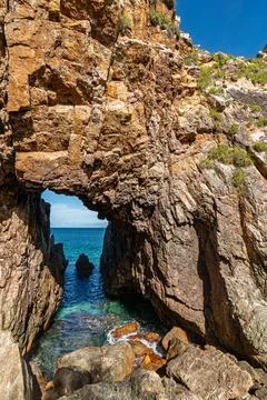 Vertical View Through Natural Stone Arch to Turquoise Sea in Quy Nhon Stock Photos
