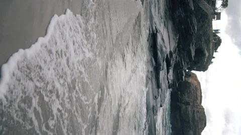 Vertical view of tide come in and stairs leading to the beach in the background. 스톡 동영상 170149277
