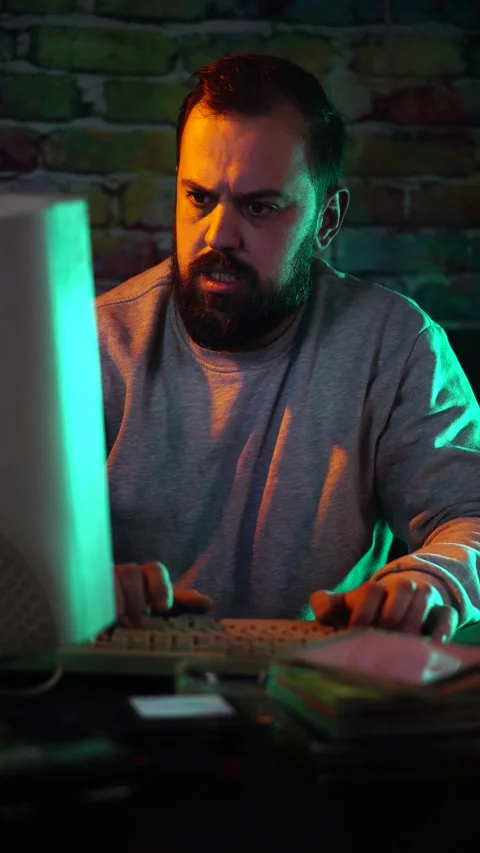 Vertical View, Tired IT Guy From 1980's Working Late NIght on Computer With CRT Stock Footage 302889880