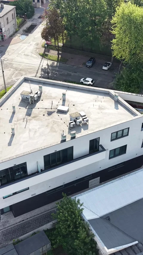 Vertical view. Top down drone view of modern building rooftop HVAC units Stock Footage 348630891