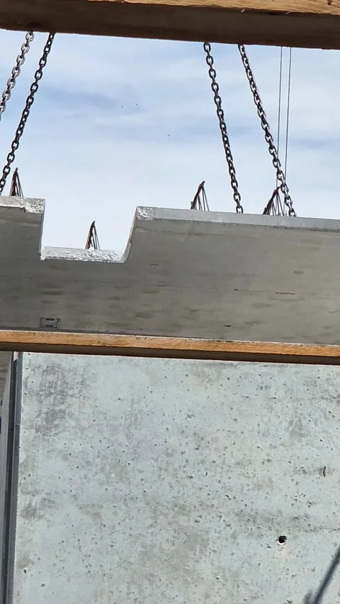 Vertical view of tower crane lifting prefabricated concrete slab Stock-Footage 336743319