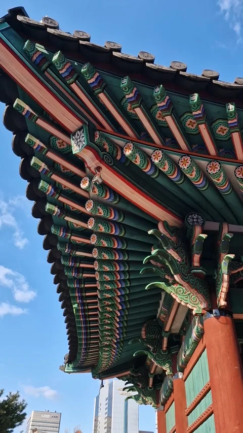 Vertical View of Traditional Korean Dancheong Paintings on Curved Eaves at Stock Footage 346898044
