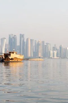 Vertical view of a traditional wooden dhow on the calm water of the Doha Cornich Stock Photos