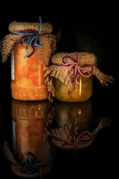 Vertical view of two glass jars of tasty jam with decoration Stock Photos