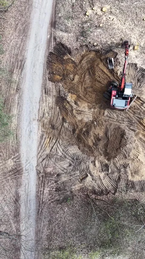 Vertical view. Two trucks and an excavator on a construction site Stock Footage 348630777