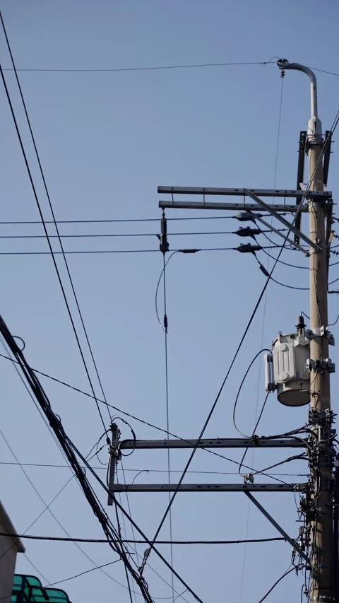 Vertical view of urban utility pole with complex network of power lines Stock Footage 310488001