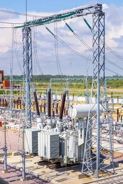 Vertical view of various elements and high-voltage insulators of a transforme Stock Photos