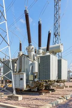 Vertical view of various elements and high-voltage insulators of a transforme Stock Photos