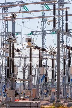 Vertical view of various elements and high-voltage insulators of a transforme Stock Photos