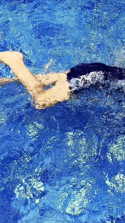 Vertical view of vivid blue pool water forming sparkling ripples and flowin.. Stock Footage 340115979