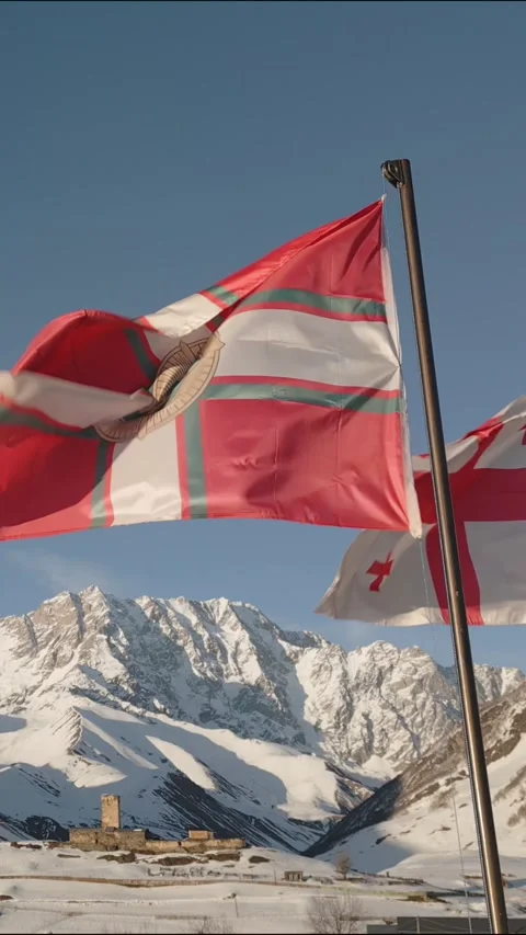 Vertical view waving flags in front of Lamaria Monastery with snow-covered .. Stock Footage 312060672