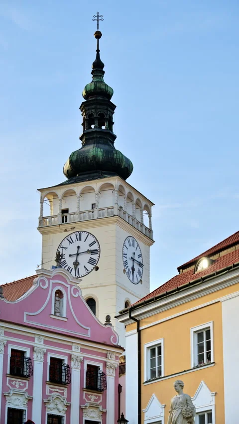 Vertical view of a white clock tower with a green baroque cupola above pastel Video stock 342257222