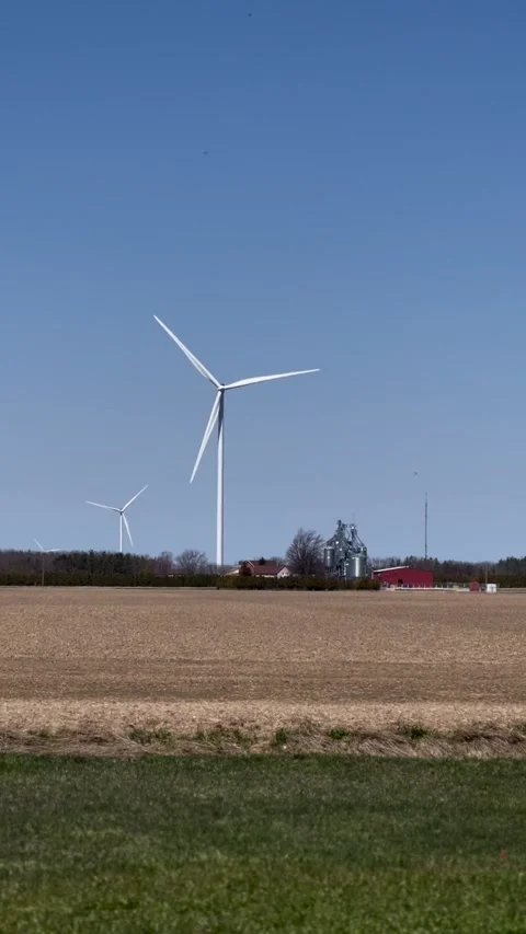 Vertical view of wind turbine in the field at noon time Stock Footage 238490045