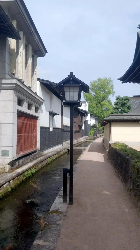 Vertical View of Wooden Lantern and White Warehouses Stock Footage 346649320