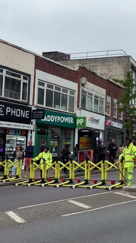 Vertical view of workers placing road barriers for Bromley parade event Video stock 334968136