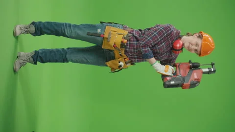 Vertical ViewConfident Female Builder Lifting Perforator to the Side and Smiling Video stock 224920110