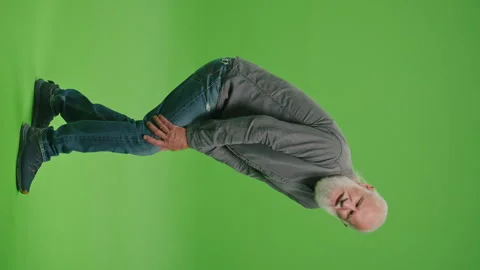 Vertical View.Green Screen. An Old Man Who Has Pain in His Knee. Video stock 263392509