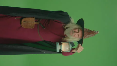 Vertical view.Green Screen.An Old Wizard With a Lamp Looks Into the Distance. Stock Footage 236640378