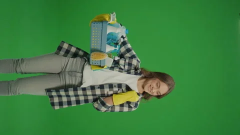 Vertical View.Green Screen. A Satisfied Young Woman Housewife in Yellow Gloves. Stock Footage 249415947