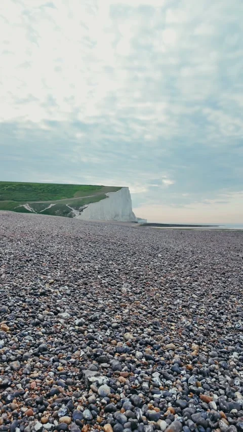 Vertical walking view on calm pebble beach with wooden groynes Stock Footage 309768655