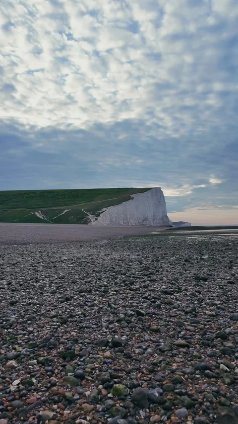 Vertical walking view on calm pebble beach with wooden groynes Stock Footage 309768663