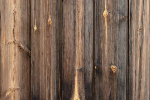A vertical wall made of old pine boards. Stock Photos