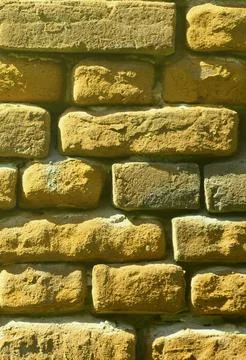 Vertical wall texture of several rows of very old brickwork made of red brick Fotos Stock