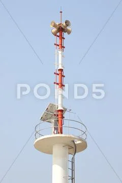 Vertical warning tower tsunami on blue sky. Stock Photos
