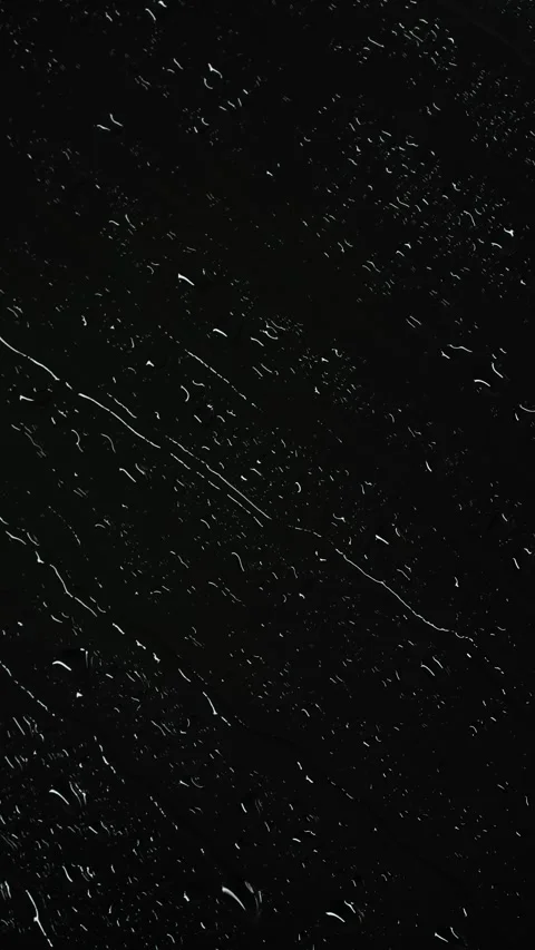 Vertical water rainfall, rain drops falling on window glass on black background Stock Footage 290486787