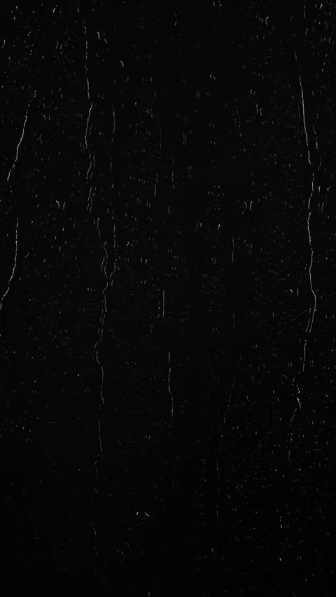 Vertical water rainfall, rain drops falling on window glass on black background Stock Footage 293430624