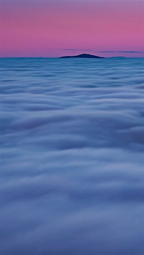 Vertical waves of dreamy clouds heaven moving like a ocean water at blue hour Stock Footage 295037465