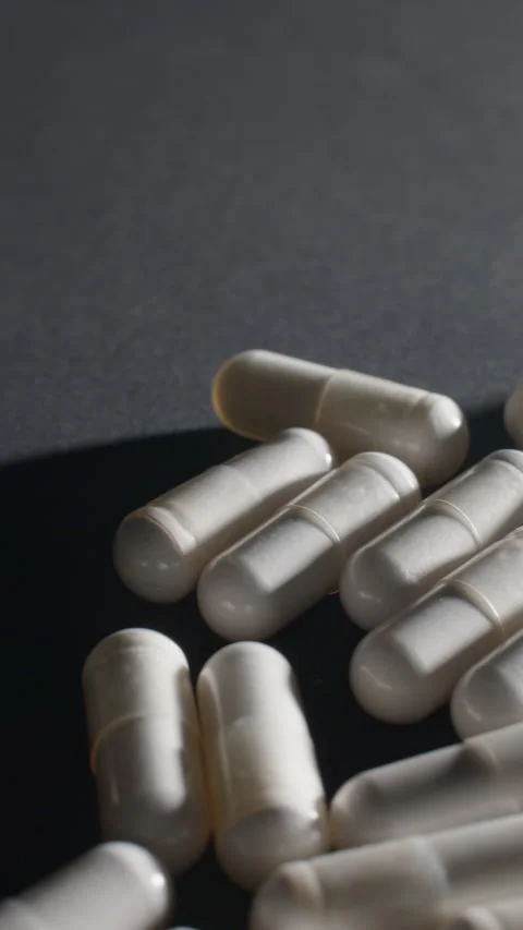 Vertical White Magnesium Capsules Macro Video stock 332371427