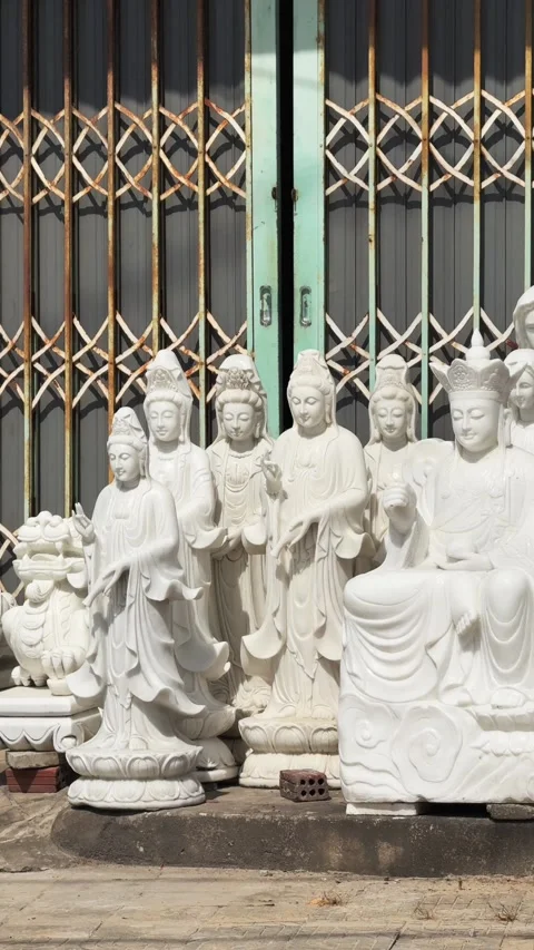 Vertical White Marble Guanyin and Laughing Buddha Statues at Stone Carving Shop Video stock 343802131