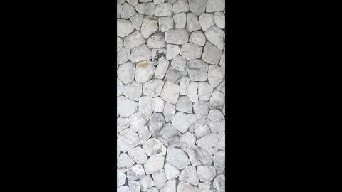 Vertical white natural stone wall texture with irregular rock pattern. Stock Footage 330150081
