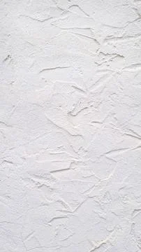 Vertical white plaster wall texture with rough surface and irregular patterns Stock Photos