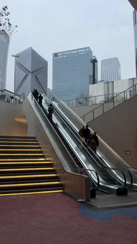 Vertical Wide Low-Angle Shot of Outdoor Escalators and Illuminated Stairs at Stock Footage 345349108