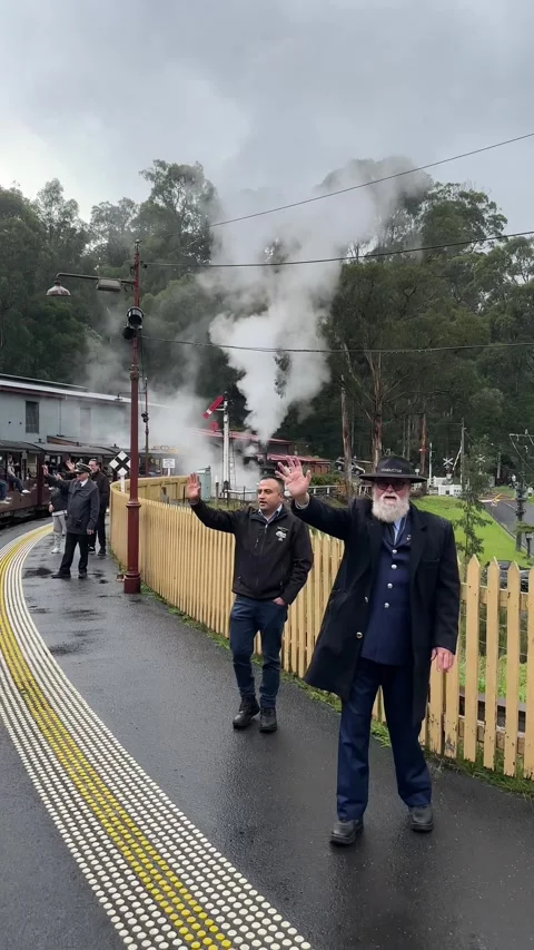 Vertical Wide Shot of Bearded Conductor and Passenger Waving at Puffing Billy Stock Footage 345777821