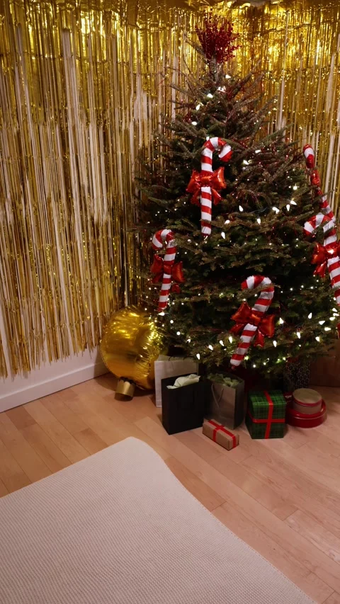 A Vertical Wide Shot Of A Christmas Tree With Gold Tinsel Background Stock Footage 313701347