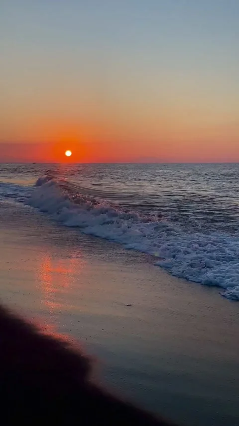 Vertical wide shot of deep golden sunset over Bali beach ocean Stock Footage 336494283