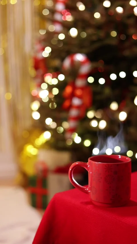 A Vertical Wide Shot Of A Festive Red Mug with Steam on Holiday Table Stock Footage 313705593