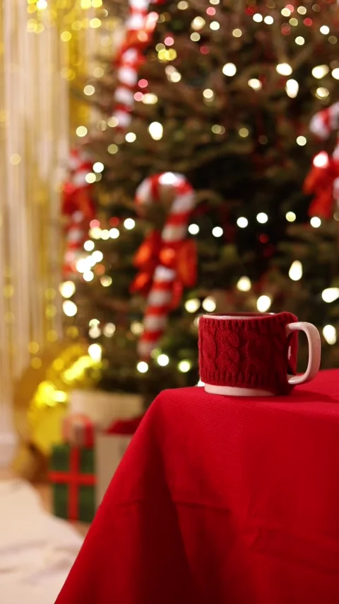 A Vertical Wide Shot Of A Red Mug With Knit Sweater On Holiday Table Stock Footage 313706951