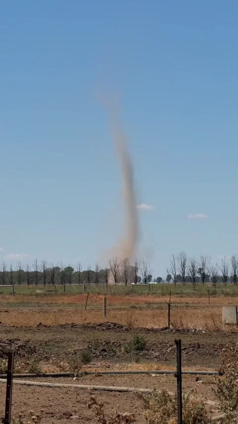 Vertical Wide Shot of a Tall Dust Devil Whirlwind Spinning Across Agricultural 스톡 동영상 345349197
