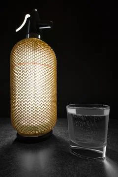 Vertical wide studio shot of backlit, luxury looking vintage soda siphon with Stock Photos