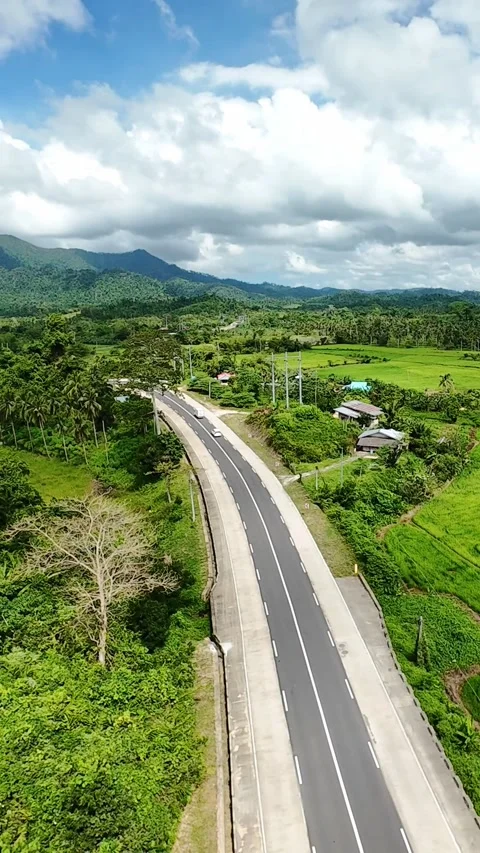 Vertical winding road through tropical hills and rice fields in Palawan Stock-Footage 318900077