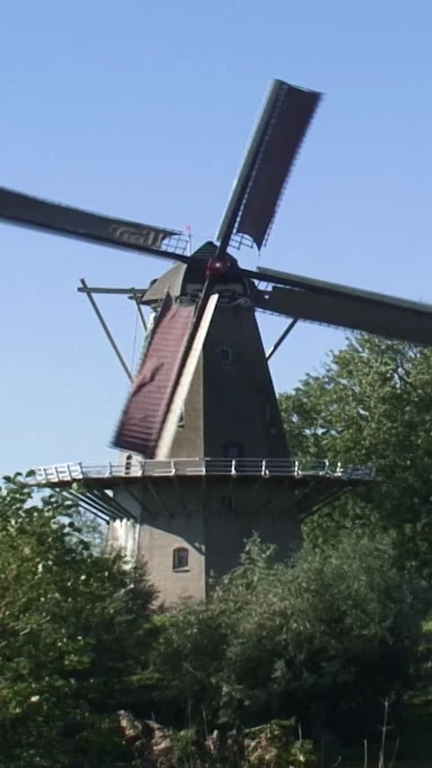 Vertical - windmill operating on the ramparts of a fortified town Stock Footage 308463282